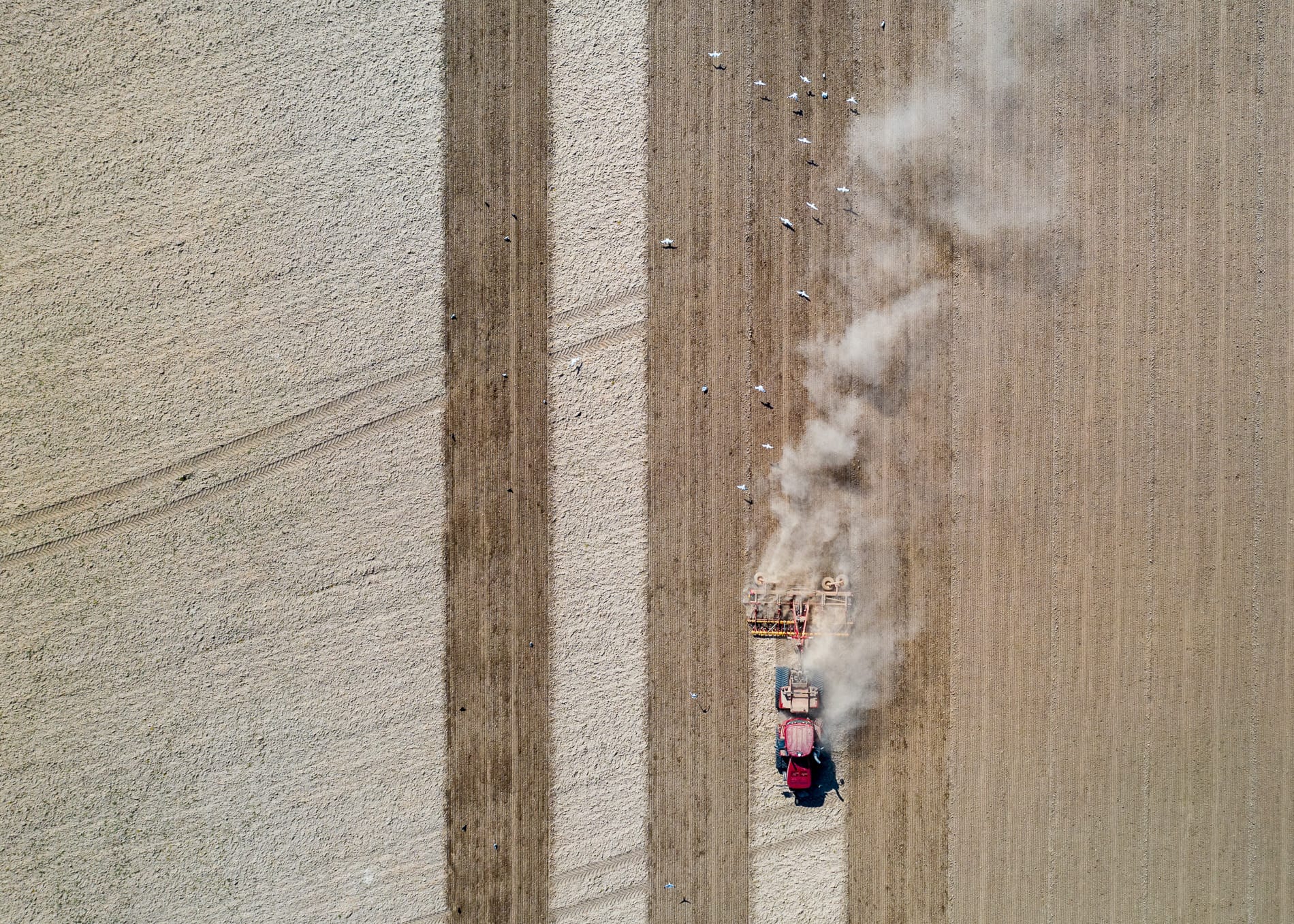 Looking straight down on a tractor ploughing a field